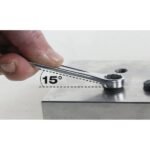 A Beta Tools 10 Combination Wrench used at a 15° offset angle, demonstrating superior leverage and clearance on a metal surface. Get it at Wrenchers.com.