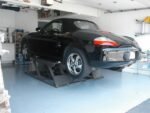 BendPak LR-60P 5175728 portable 6K lb scissor lift lifting a black coupe. Compact footprint, pro-level strength.
