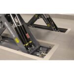 Detailed view of the BendPak MDS-6LPF flush-mount lift base and hydraulic components.