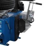 Side view of the Hofmann Monty 1675-SS tire changer highlighting the bead breaker assembly and ergonomic control handle