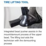 Close-up of the Hofmann Monty 1675-SS tire lifting tool with integrated bead pusher assisting upper bead mounting and demounting