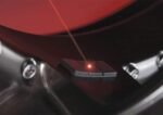 Laser dot highlighting the correct adhesive wheel weight position on the rim.