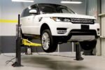 Range Rover SUV raised on MaxJax M7K two-post portable garage lift.
