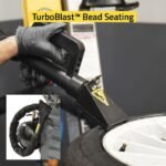 Action view of the R76ATR-L 110V tire changer’s TurboBlast™ bead seating system delivering fast, controlled air bursts for quick and reliable bead sealing