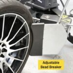 Detailed shot of the R76ATR-L 110V tire changer’s adjustable bead breaker blade applying controlled pressure to safely separate stubborn beads